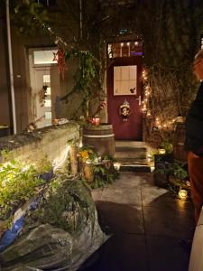 a front door of a house with christmas lights at Cozy Apartment in Estinnes – 40 sqm with a fenced garden. in Estinnes-au-Val