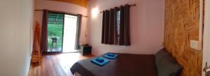 sala de estar con sofá y ventana en Bamboo Hut Bangalow, en Ko Mook