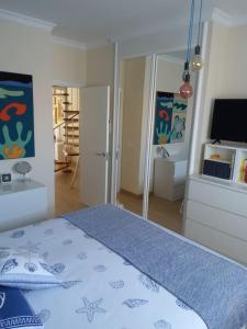 1 dormitorio con 1 cama con manta azul y espejo en Vacanze da sogno, en San Miguel de Abona