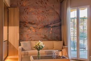 a living room with a couch and a painting on the wall at Miramare Suites in Sestri Levante