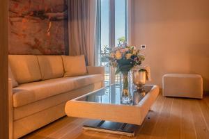 a living room with a couch and a glass table at Miramare Suites in Sestri Levante
