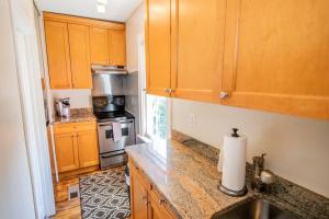 a kitchen with wooden cabinets and a counter top at Downtown Annapolis King George 3rd Floor Hideaway in Annapolis