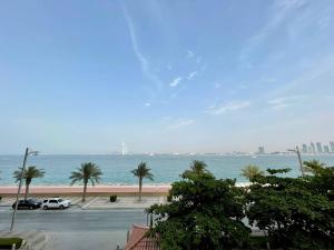 a view of the ocean with palm trees and a parking lot at Luxury residential apartments located in Anantara area , pool , beach , free parking in Dubai