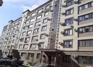 a large apartment building with a lot of windows at City House in Aktau