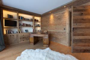 a room with a wooden wall with a desk at Chalet Le Ferme Combloux Rhone-Alps in Combloux