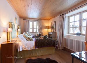 a bedroom with a bed with a dog laying on it at Chalet Le Ferme Combloux Rhone-Alps in Combloux