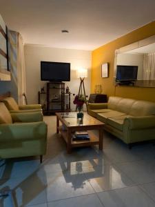 a living room with two couches and a coffee table at Hotel Acuario in Churín