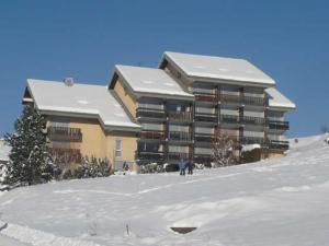 a large building on top of a snow covered slope at Studio Villard-de-Lans, 1 pièce, 4 personnes - FR-1-515-68 in Villard-de-Lans