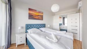Posteľ alebo postele v izbe v ubytovaní Prywatne apartamenty Sun & Snow w obiekcie Ustronie Apartments