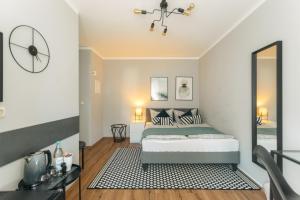 a bedroom with a bed and a clock on the wall at Das Schlafgut Dessau in Dessau