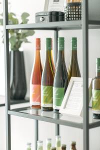 a shelf with bottles of wine on it at Das Schlafgut Dessau in Dessau