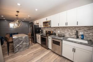 a kitchen with white cabinets and a counter top at Dawsonville Retreat in Dawsonville