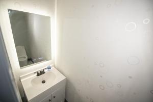 a white bathroom with a sink and a mirror at Dawsonville Retreat in Dawsonville