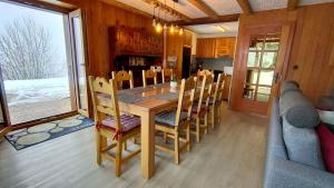 - une salle à manger avec une table et des chaises en bois dans l'établissement Belle Vie sur les pistes, à Veysonnaz