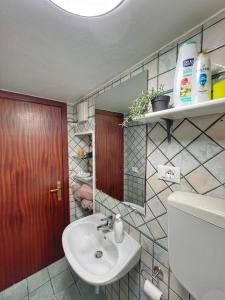a bathroom with a sink and a mirror and a toilet at casa vacanze Iside in Termini Imerese