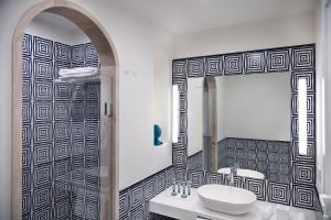 a bathroom with a sink and a shower at Pazziella Garden & Suites in Capri