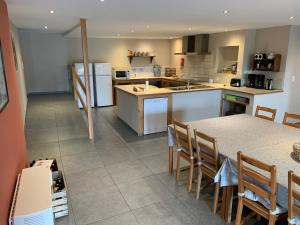 a kitchen with a table and chairs and a counter top at Coeur de Boeur in Houffalize