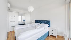 Posteľ alebo postele v izbe v ubytovaní Prywatne apartamenty Sun & Snow w obiekcie Ustronie Apartments