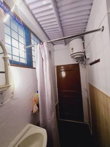 een badkamer met een toilet en een douchegordijn bij Green Diamond Homestay in Dehradun