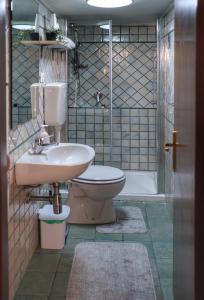 a bathroom with a sink and a toilet and a shower at casa vacanze Iside in Termini Imerese