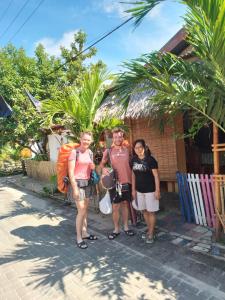 a group of people standing outside of a house at FRANGKY HOMESTAY in Manado