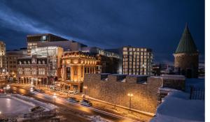 a city at night with buildings and street lights at Le Capitole Hotel in Quebec City