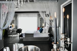 a bedroom with a bed with curtains and a table at Suite avec piscine privée in Chelles