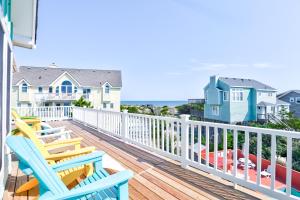 a balcony with chairs and a view of the ocean at The Lost Lobstah 969 in Avon
