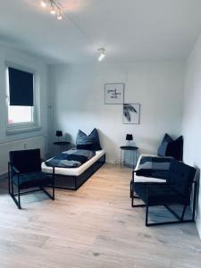 een woonkamer met 2 stoelen en een bank bij modernes 1-Raum Apartment für Monteure (WORK 1) in Cottbus