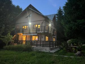 a large white house with its lights on at The View Sinaia-Busteni in Buşteni
