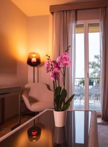 a living room with a vase of flowers on a glass table at Miramare Suites in Sestri Levante