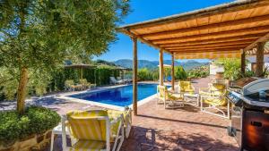 un patio trasero con piscina y pérgola en Villa Los Rosales El Gastor by Ruralidays, en El Gastor
