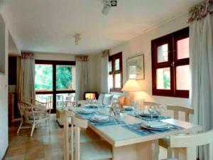 a living room with a table with chairs and a dining room at Rincon del Este in Punta del Este