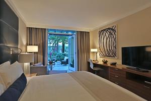 a hotel room with a bed and a desk and a television at InterContinental at Doral Miami, an IHG Hotel in Miami