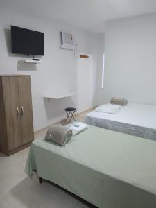 Ένα ή περισσότερα κρεβάτια σε δωμάτιο στο Hotel Vila Bela +6 φωτογραφίες