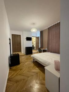 a bedroom with a bed and a television in it at Schei Central Studios in the heart of Brasov in Braşov