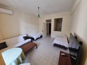 a hospital room with two beds and a tv at Orange Grove Apart Hotel in Alanya