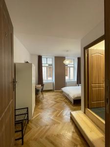 a room with a bedroom with a bed and a mirror at Schei Central Studios in the heart of Brasov in Braşov