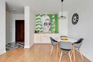 a kitchen and dining room with a table and chairs at Modern Old Town - Apartament w centrum Gdańska by Grand Apartments in Gdańsk