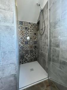 a shower with a glass door in a bathroom at Agriturismo Fattoria Primaluce - Appartamento Quercia in Spino dʼAdda