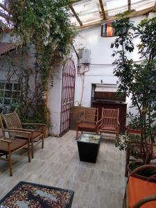 a courtyard with chairs and a piano in a building at Casa de Mama Cusco 2-The Ecohouse in Cusco