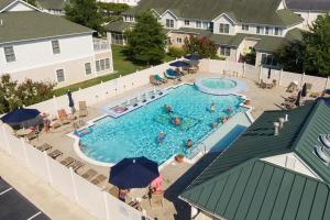 an overhead view of a swimming pool with people in it at The Tides -- 20007 Sandy Bottom # 4202 in Rehoboth Beach