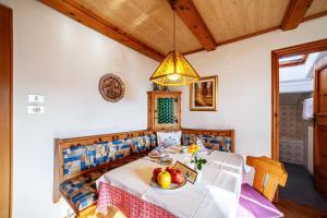 a dining room with a table with fruit on it at Adang Ferienwohnung Mutspitz in Tirolo