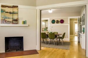 a living room with a fireplace and a table and chairs at Painted Hills in Portland