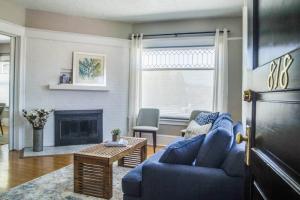 a living room with a blue couch and a fireplace at Angel's Rest in Portland