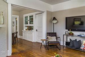 a living room with a television and a table and chairs at Silver Falls in Portland