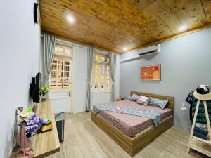 a bedroom with a bed and a wooden ceiling at Radish Cathedral Homestay in Hanoi