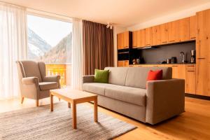 a living room with a couch and a table at All-Suite Resort Zwieselstein - Sölden in Sölden