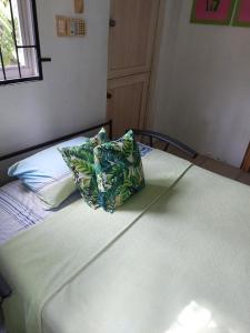 a bed with a pillow sitting on top of it at Studio 5 min from the beach in Kas Chikitu