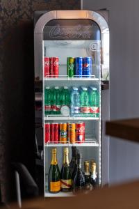 an open refrigerator filled with sodas and soda cans at Benjoi Camere in SantʼArpino